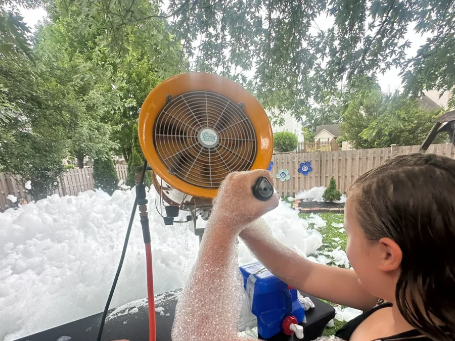 A birthday party guest operating the foam cannon