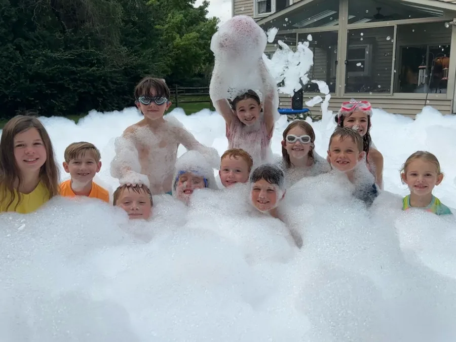 A group of birthday party kids posing in the foam