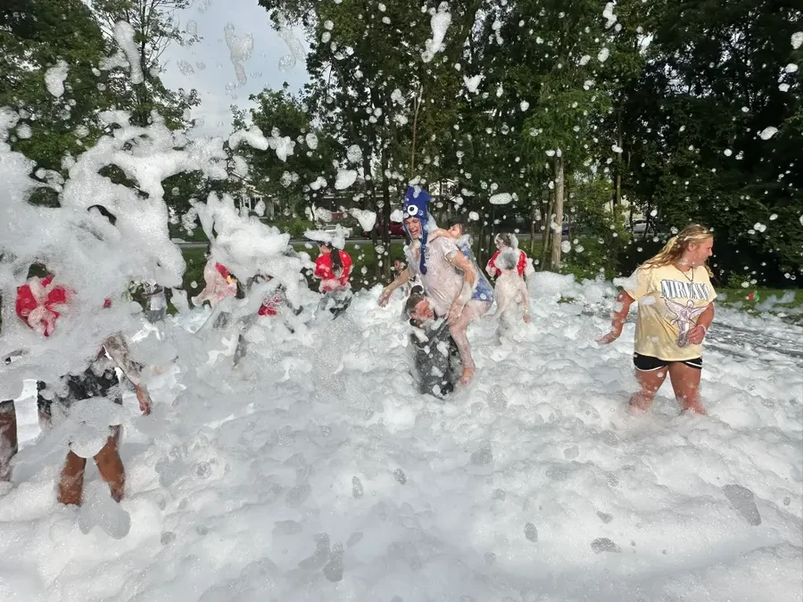 Kids playing in the foam during a daytime foam party