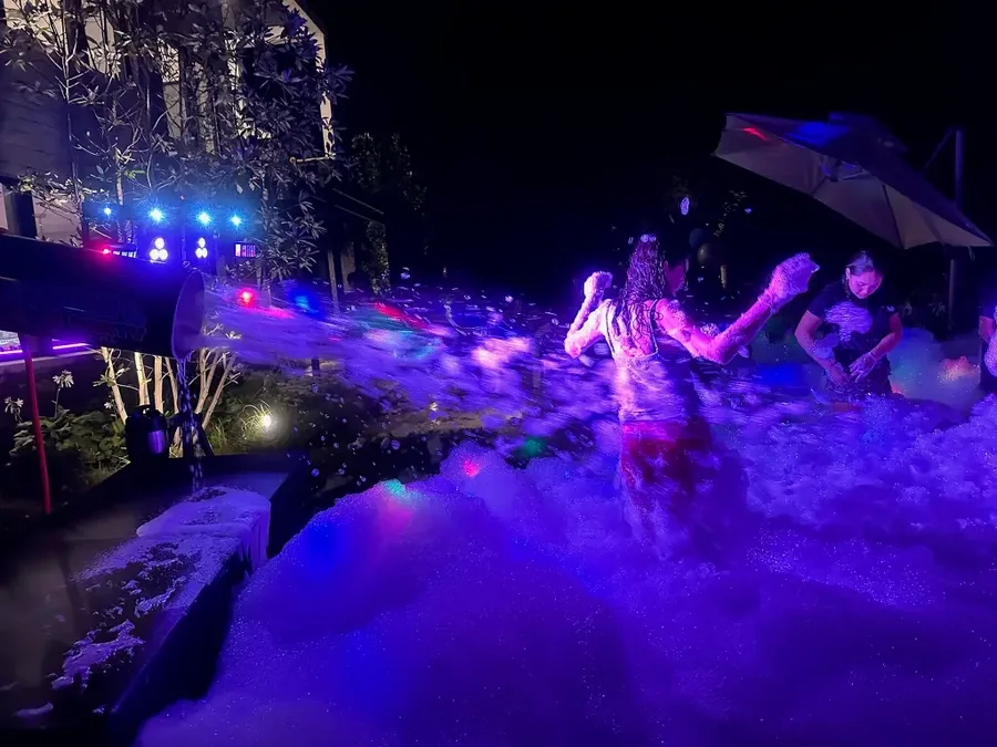 Blue glow lighting during a Night Glow foam party