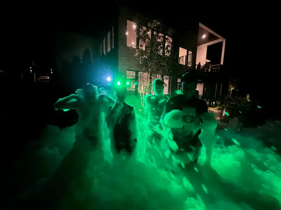 Green glow lighting during a Night Glow foam party