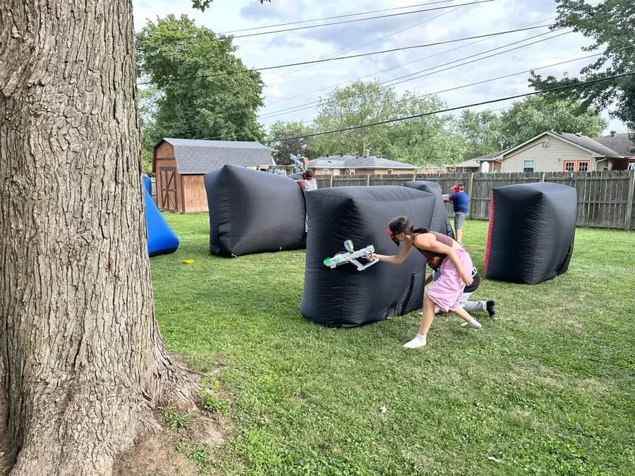 Players taking cover behind inflatable bunkers during a Gel Blaster battle