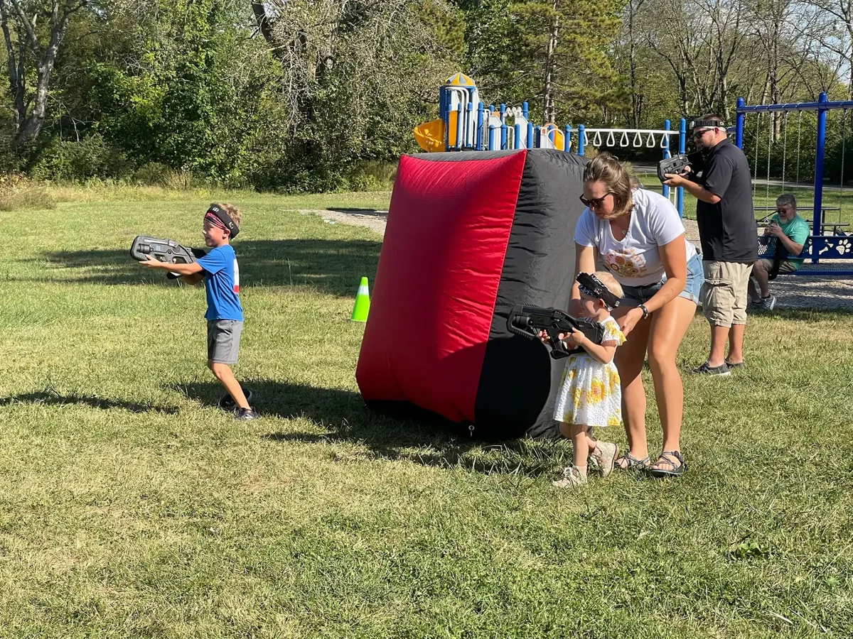 Kids enjoying laser tag during a backyard birthday party