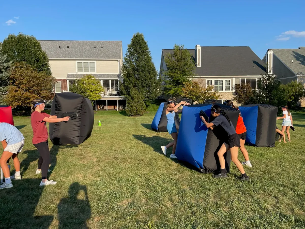Outdoor laser tag battle during a backyard birthday party