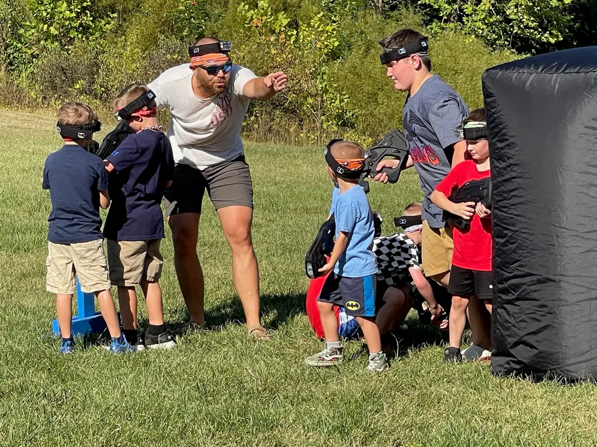 Indy Blast game coach briefing players before a laser tag birthday mission
