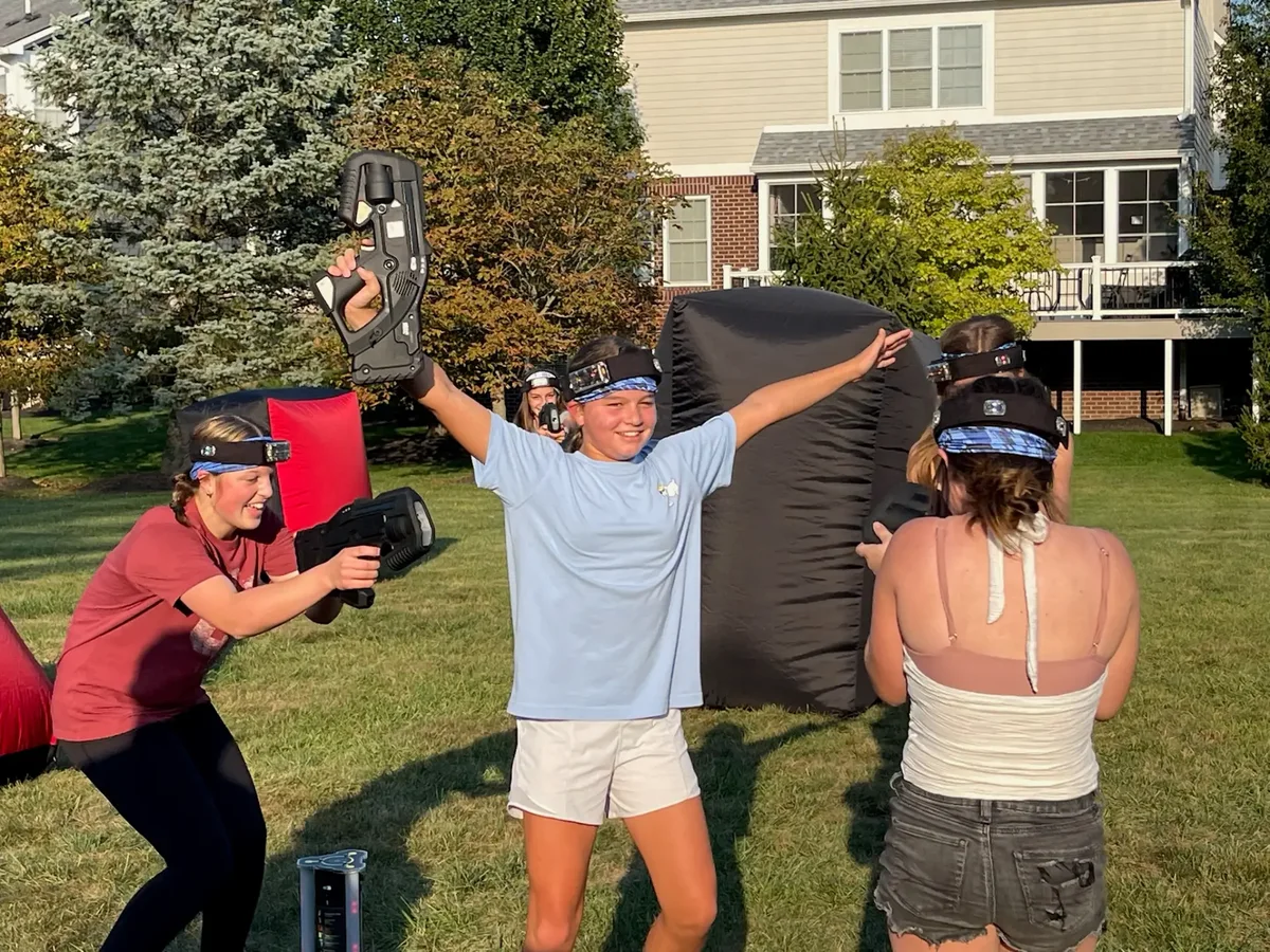 Kids celebrating a win during a backyard laser tag birthday party