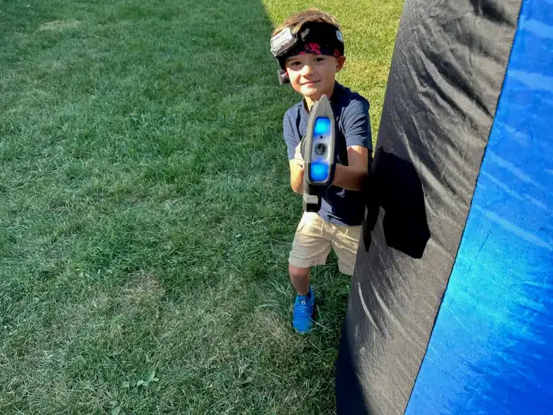 Kids playing backyard laser tag at a birthday party in Central Indiana