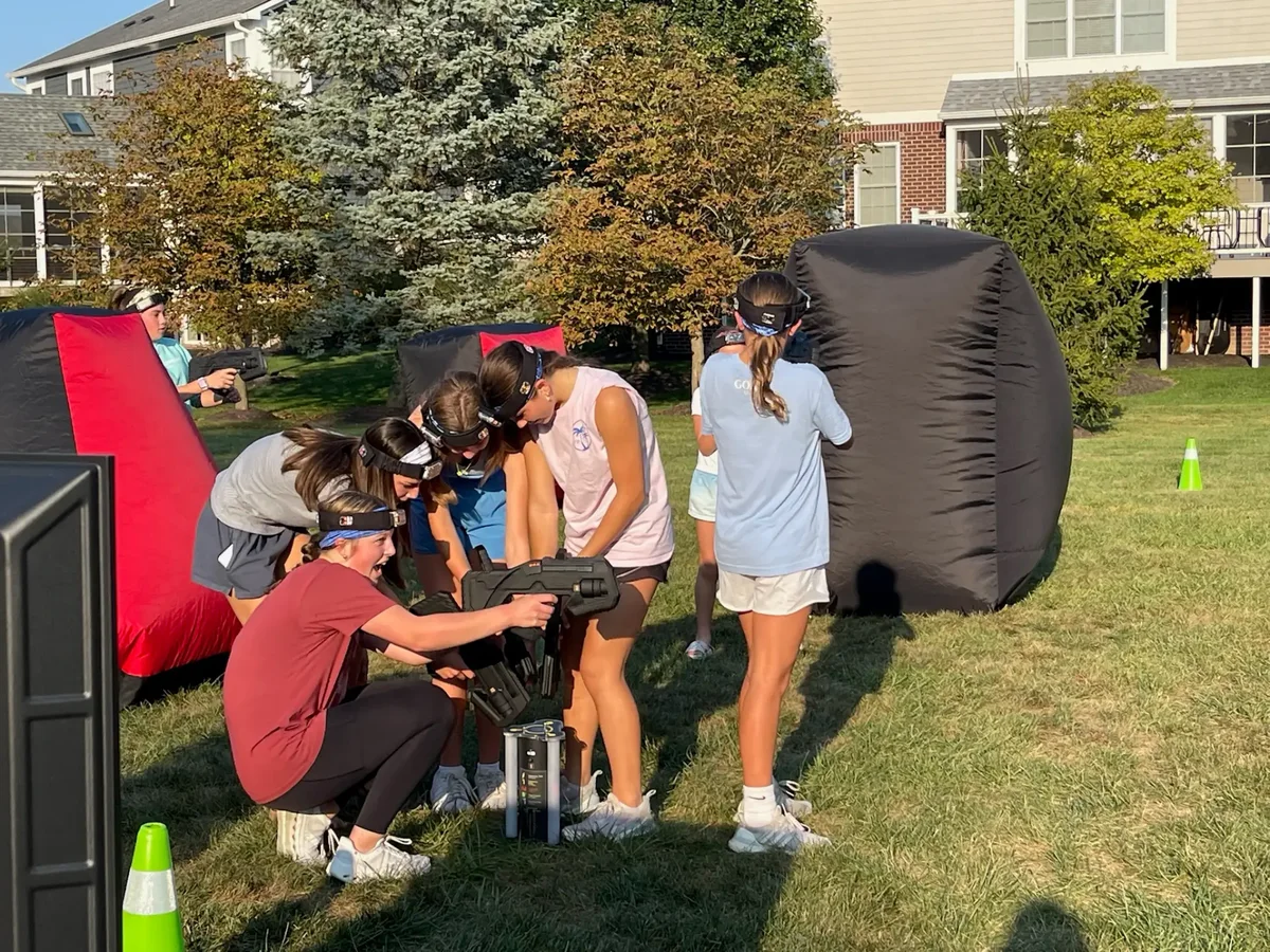 Indy Blast staff helping players gear up for a laser tag mission