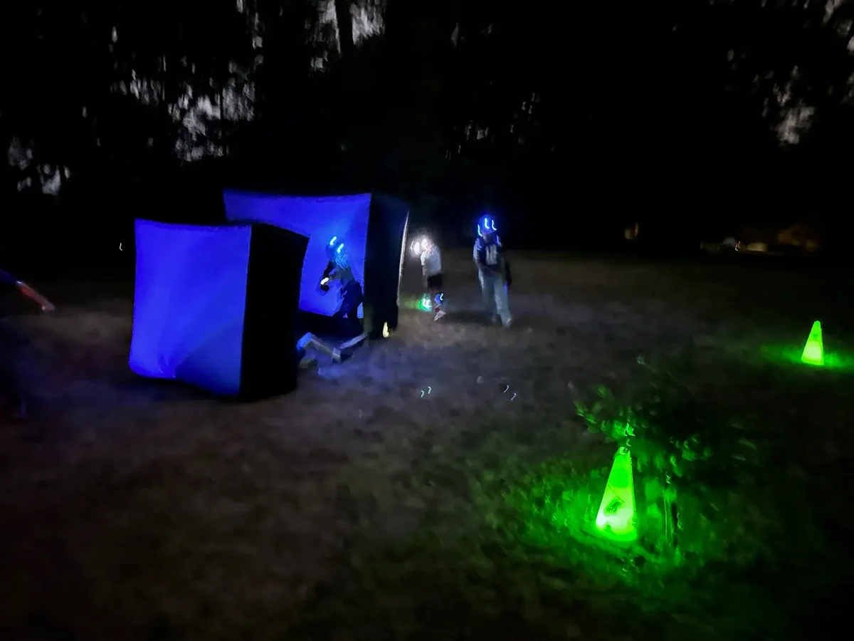 Glow-in-the-dark laser tag arena set up for a night birthday party