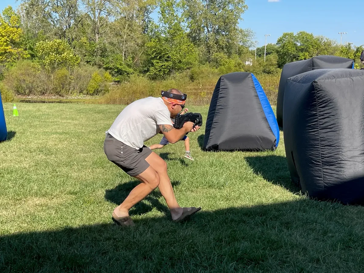 Parents joining their kids for an outdoor laser tag birthday party