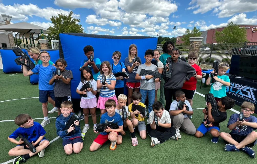Summer camp group photo with laser tag blasters at Crème de la Crème
