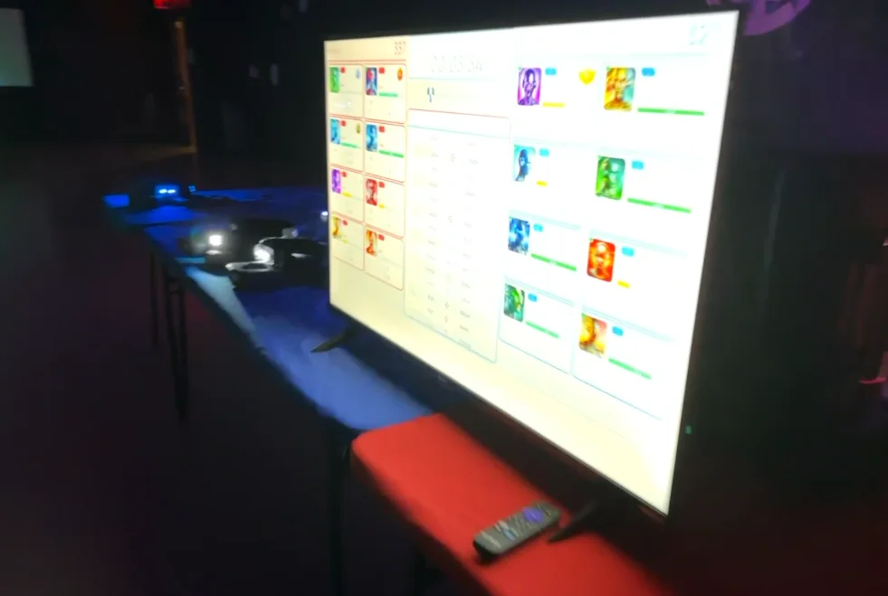 Live scoring leaderboard displayed on screen during a corporate laser tag team building event