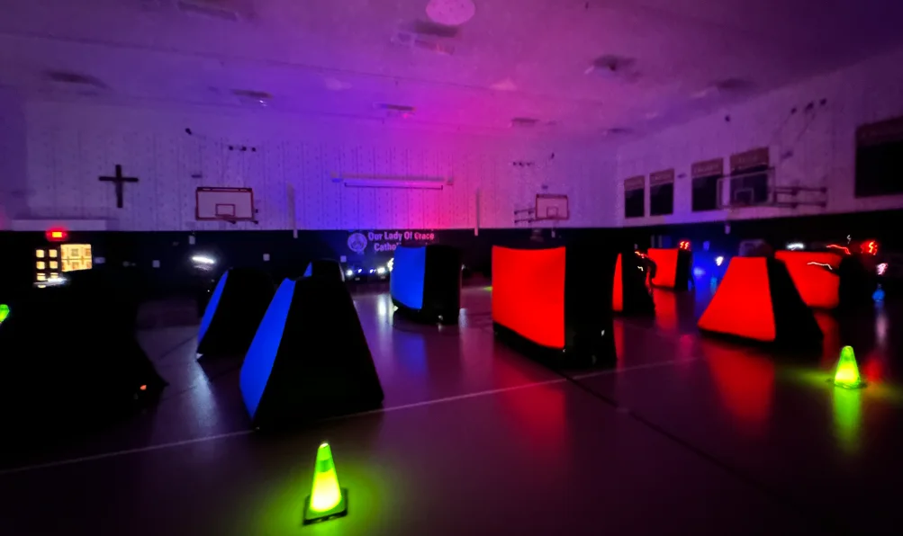 Full glow laser tag bunker arena set up in a parish gymnasium for a community event