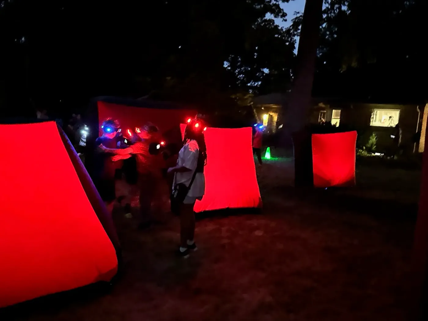 Youth group playing glow-in-the-dark laser tag at an outdoor community event