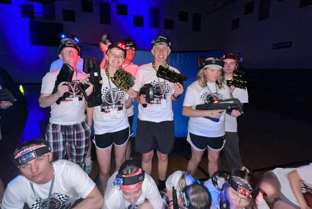 After Prom laser tag winners holding gold GOAT and MVP trophies