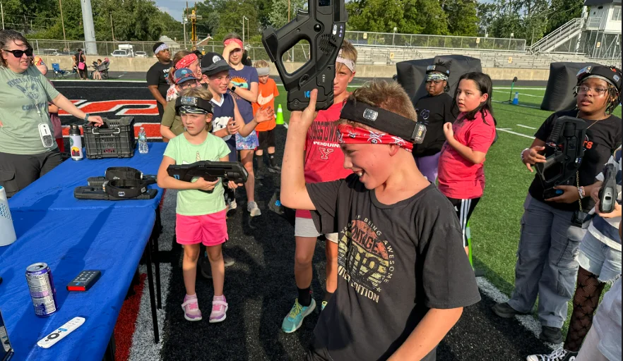 Students with headband trackers gathered at the check-in table during a Broad Ripple Middle School back-to-school event