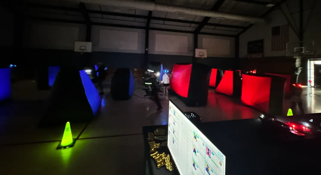 Colorful blue and red laser tag bunker arena set up in an elementary school gym for a glow event