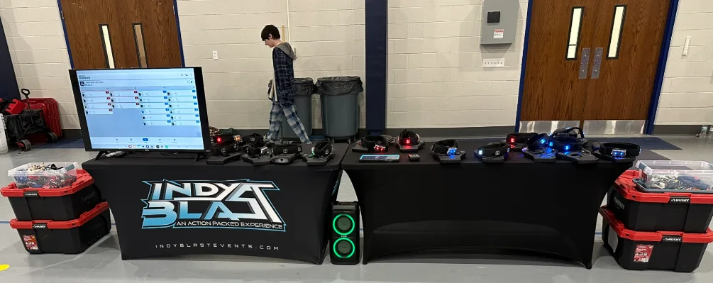Indy Blast check-in table with taggers and headsets ready for a middle school fundraiser event