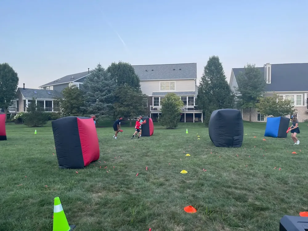 A team of players moving together between bunkers during a Nerf birthday party