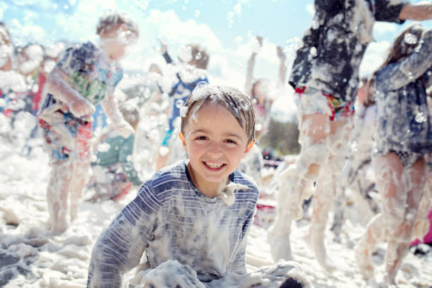 a group of children playing with foam